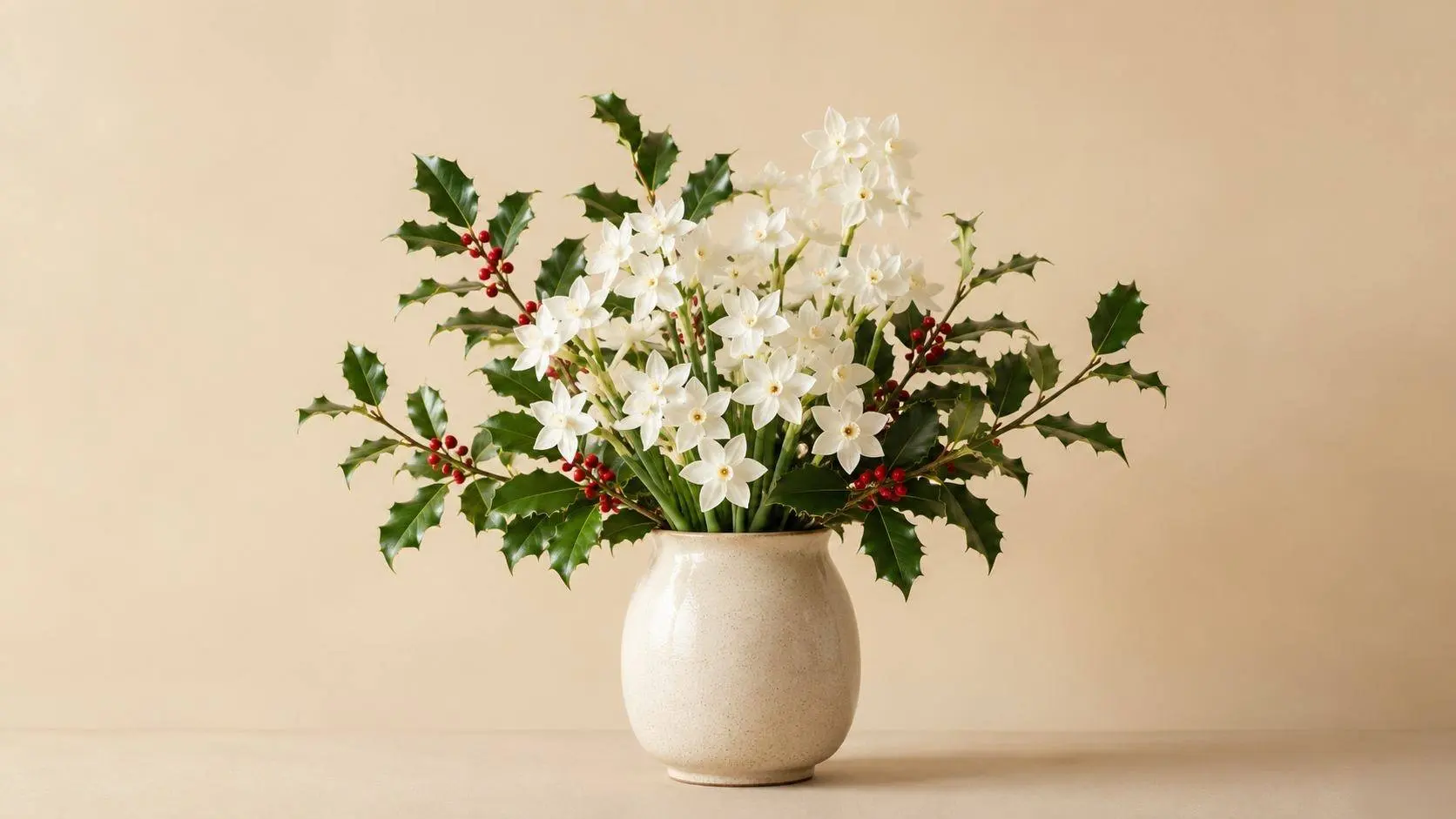 December birth flowers: white paperwhite narcissus and red-berried holly