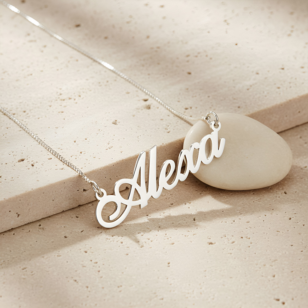 Classic Name Necklace in sterling silver resting on stone