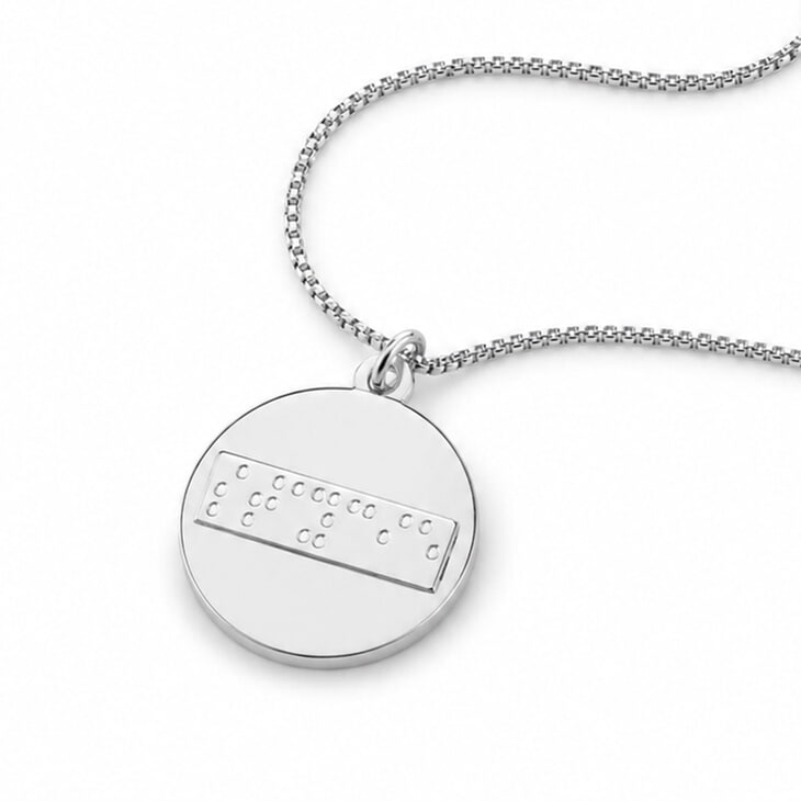 Silver Braille disc necklace featuring personalized dot pattern design