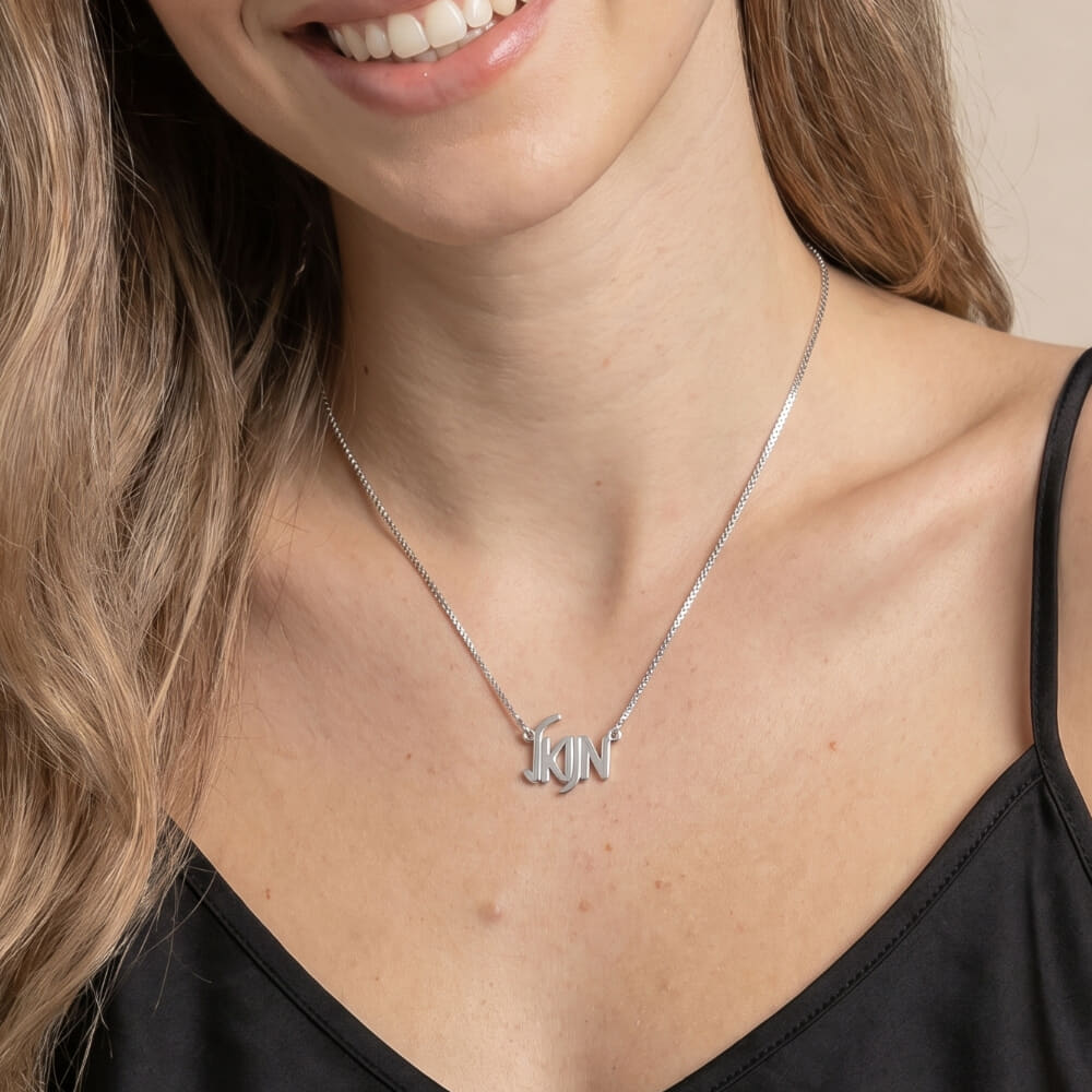 Model wearing HB28369 necklace with a stylish letter design against a neutral background