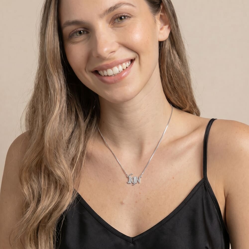 Model showcasing HB28369 necklace with a stylish letter design against a soft background