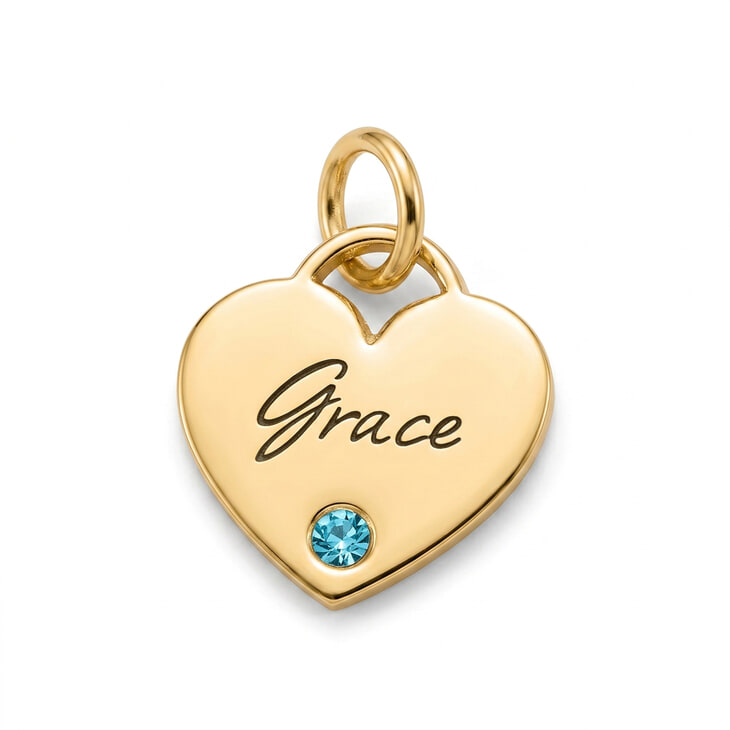 Close-up of a heart pendant with the name Grace and a birthstone charm.