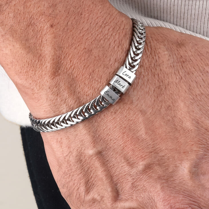 Personalized silver Dad bracelet showcasing engraved names Cora and Mark.