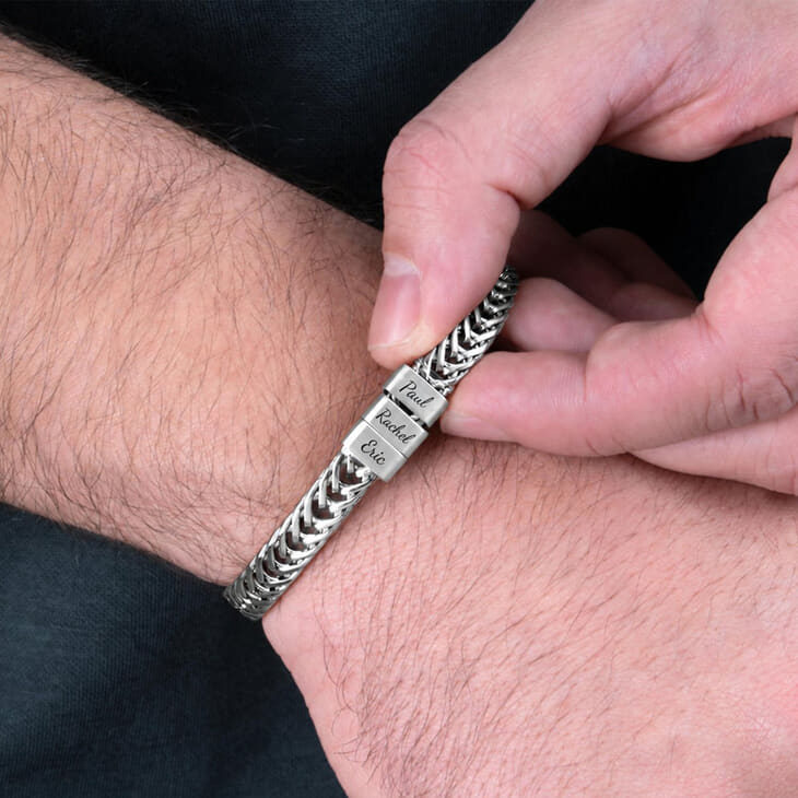 Stainless steel Dad bracelet shown being adjusted with engraved name tags