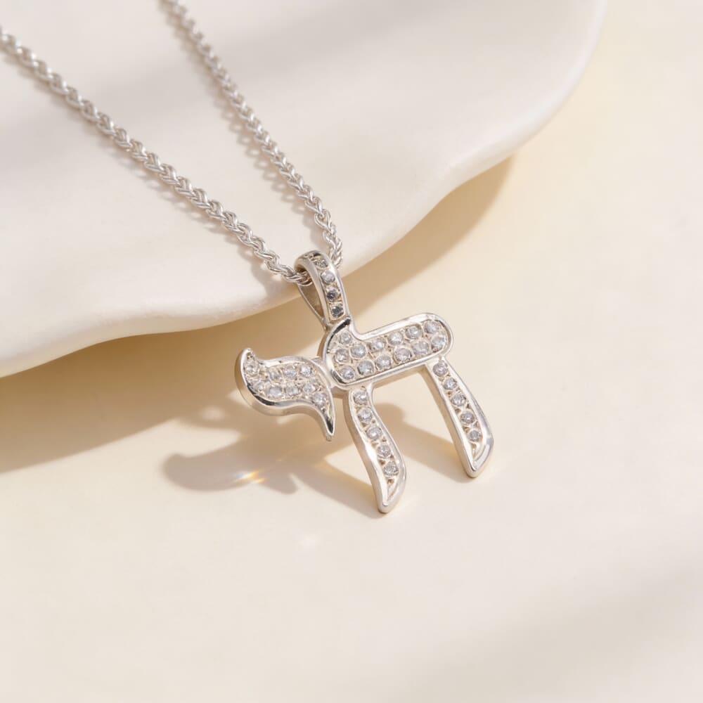 Model showcases the Handmade Hebrew Chai Necklace with Zircons, styled elegantly on a light background.