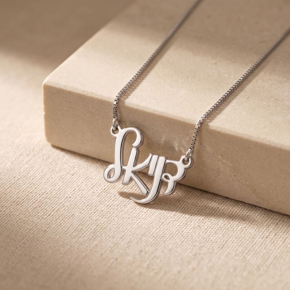 Model wears Hebrew name necklace in Ahava font, styled against a soft textured background.