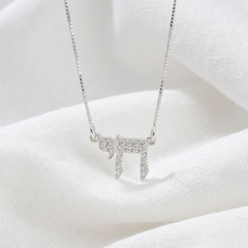 Model showcasing the Live Pendant Mini necklace with a stylish layered look