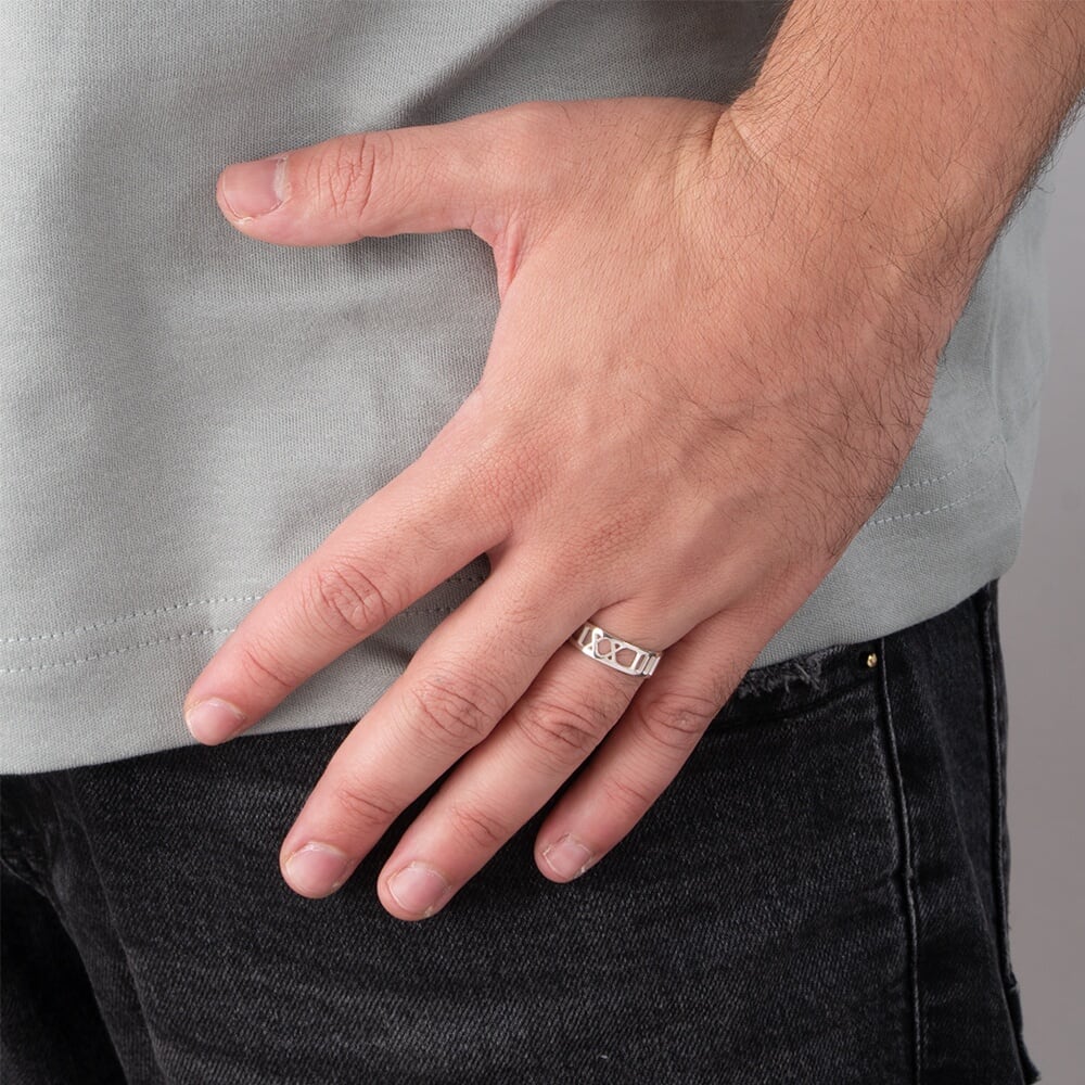 Model displaying a Mens Roman Numeral Ring with hand resting on thigh