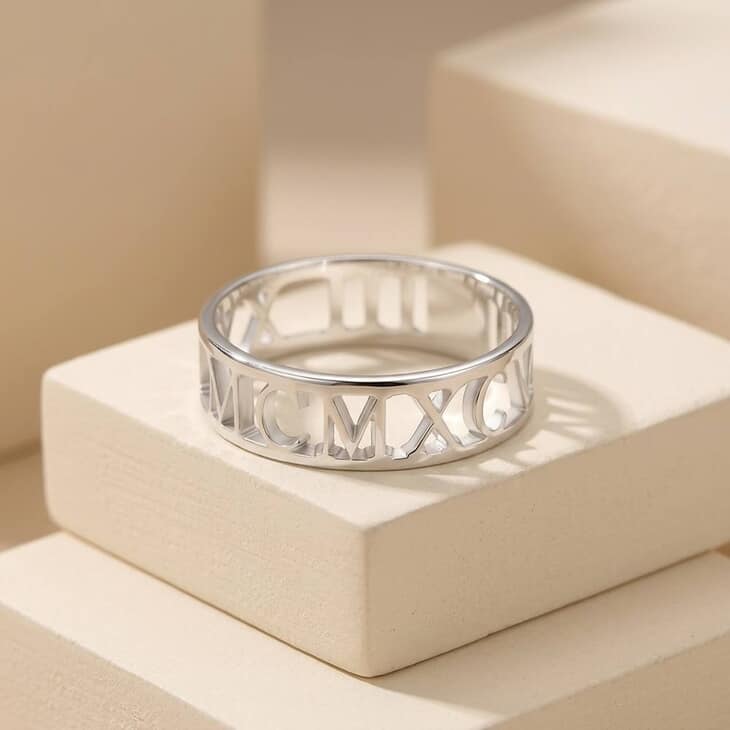 Model showcasing a Mens Roman Numeral Ring in a contemporary lifestyle context