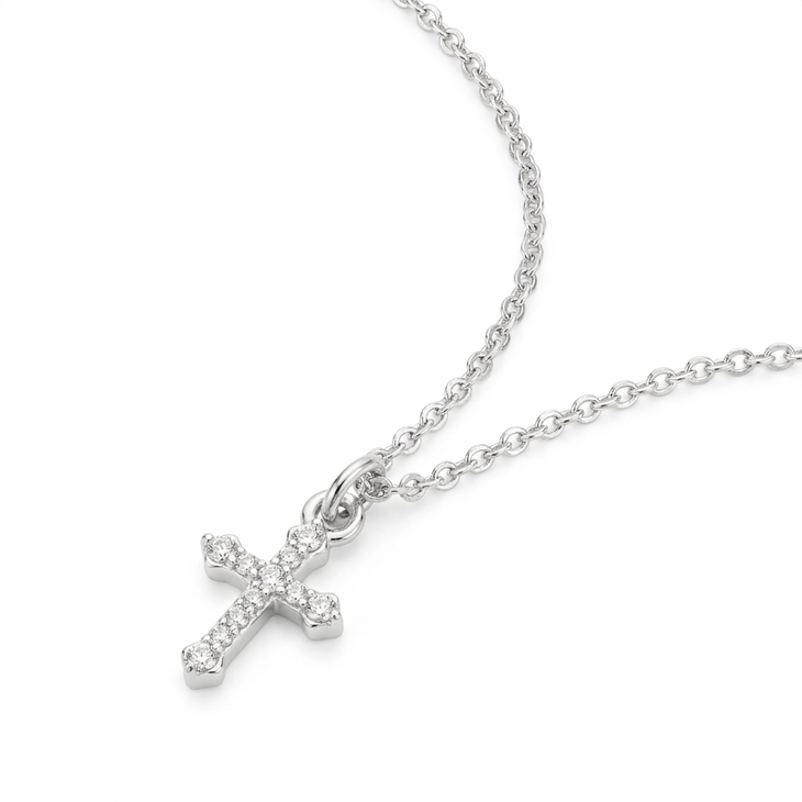 Small Inlaid Cross pendant in silver with intricate detailing and a delicate chain