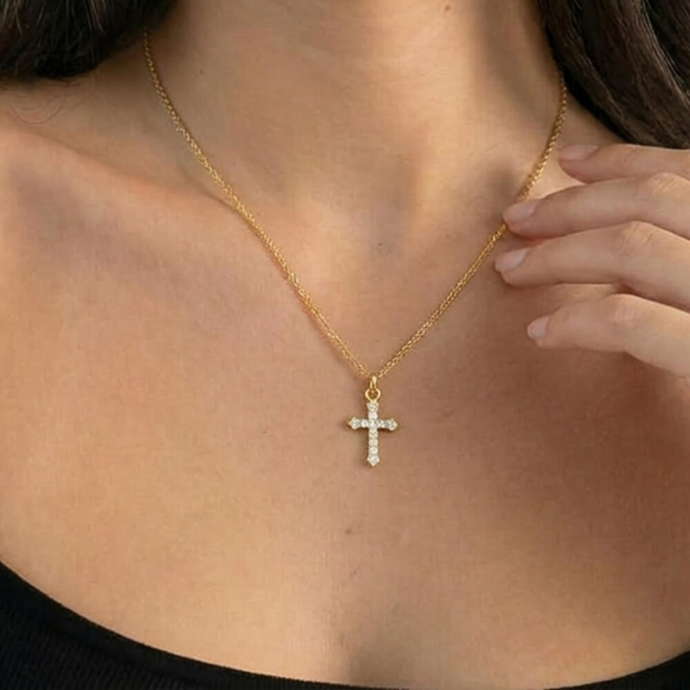 Model showcases the Small Inlaid Cross pendant with a sleek black top