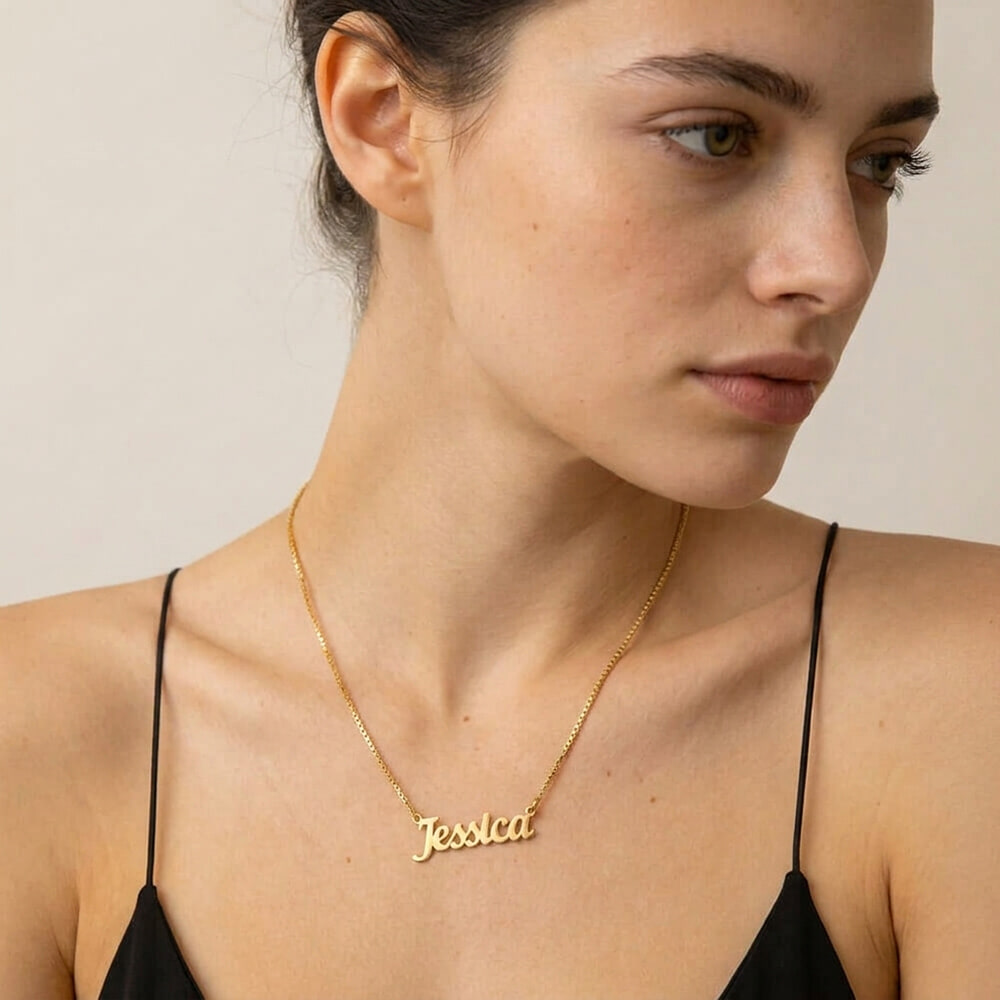 Woman showcasing The Everyday Name Necklace featuring a stylish cursive name design.
