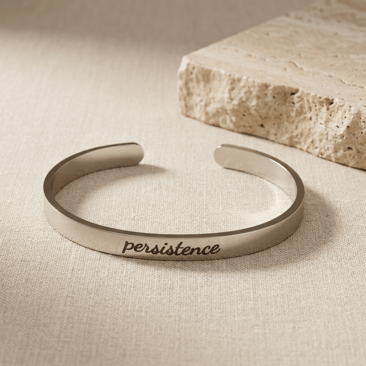Personalized custom cuff bracelet in silver featuring 'persistence' engraving
