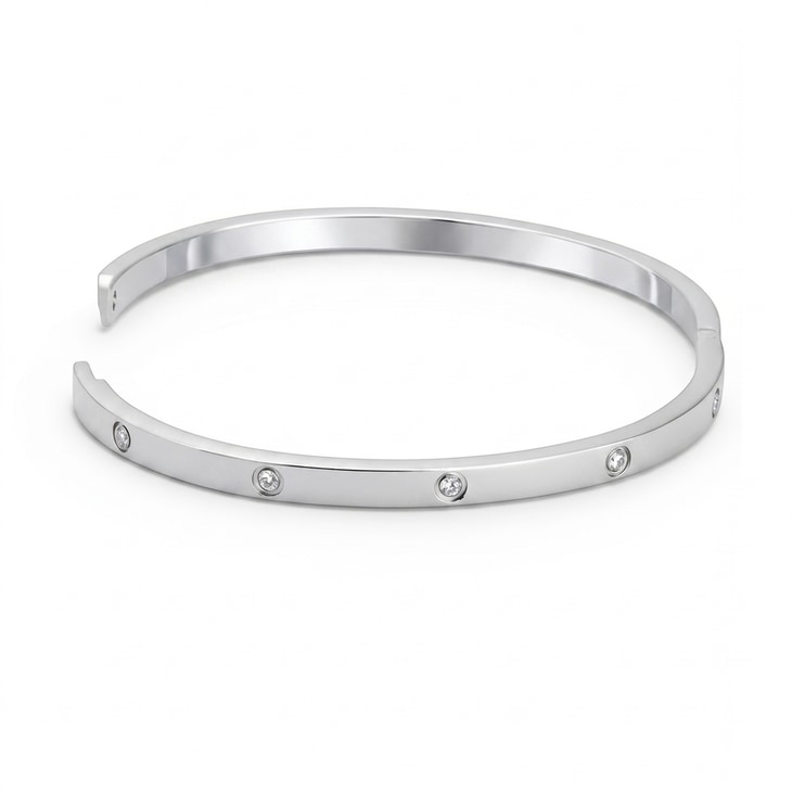 Silver minimalist bangle bracelet featuring cubic zirconia accents against a plain backdrop