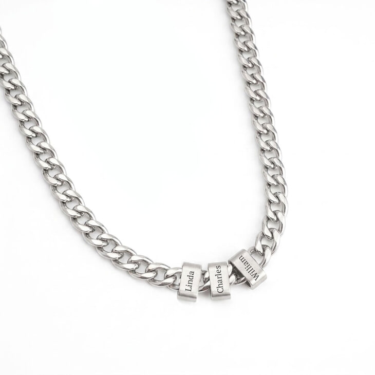 Close-up of silver personalized engraved beaded Cuban chain necklace