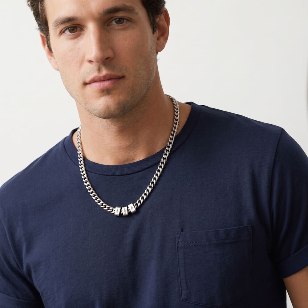 Model wearing a personalized engraved beaded Cuban chain necklace with a confident expression