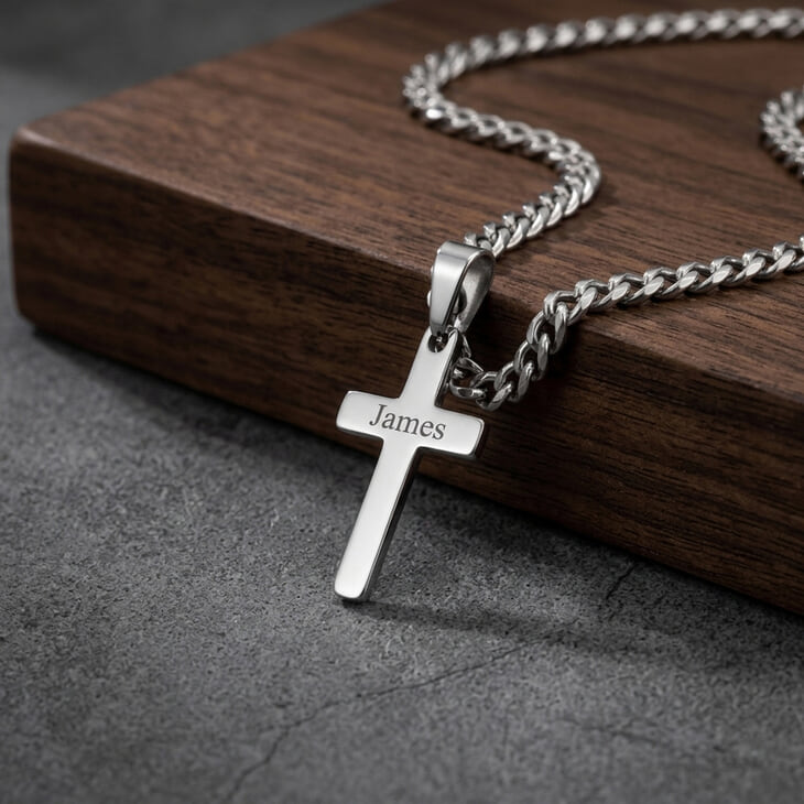 Close-up of the Custom Cross Necklace in silver with personalized engraving.