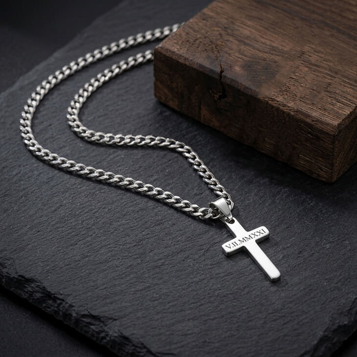 Silver Custom Cross Necklace with curb chain on a dark stone background