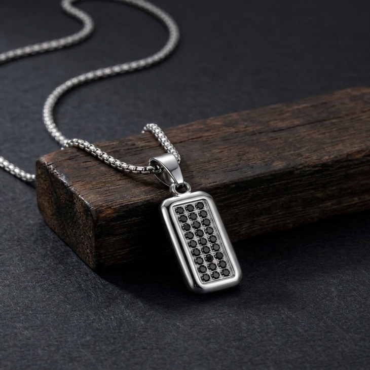 Model showcasing Men's Black Zircon Tag Necklace, featuring a bold pendant against a dark background
