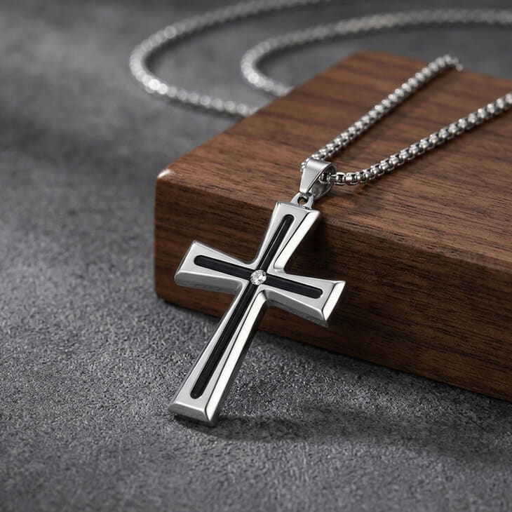Men's Black Inlay Cross Necklace in silver on a wooden surface