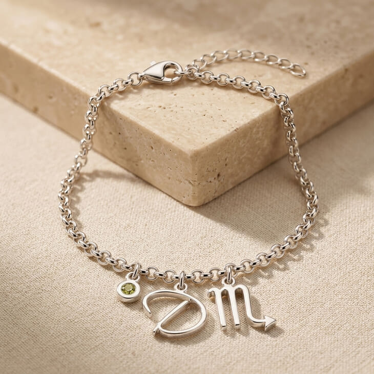 Charming bracelet showcasing zodiac script initial and vibrant birthstone charm
