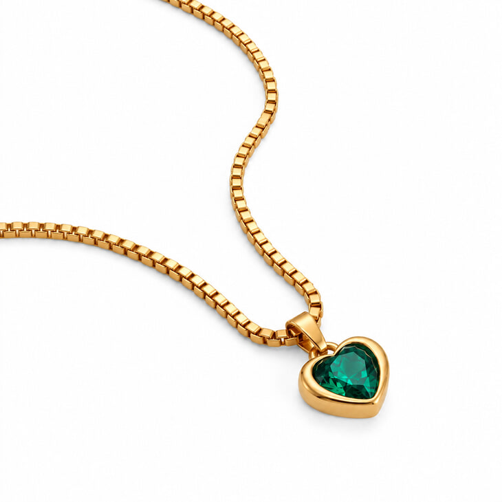 Gold heart-shaped pendant necklace showcasing a stunning green gemstone