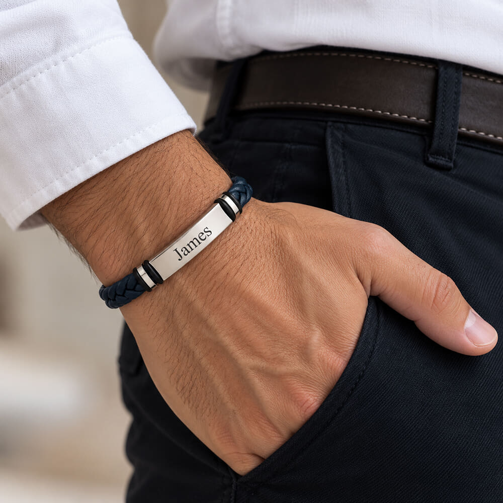 Model displaying personalized navy blue leather bracelet with an engraved name accent