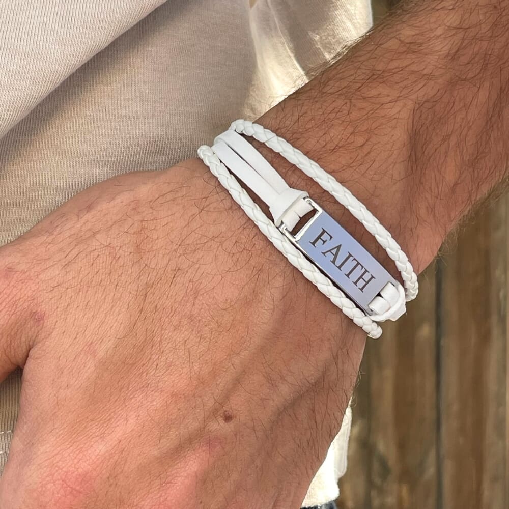 Model showcasing a personalized men's white leather bracelet with a sleek design